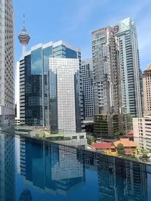 a city with tall buildings and a pool of water at RM203A Bukit Bintang Balcony Studio Infinity Pool in Kuala Lumpur