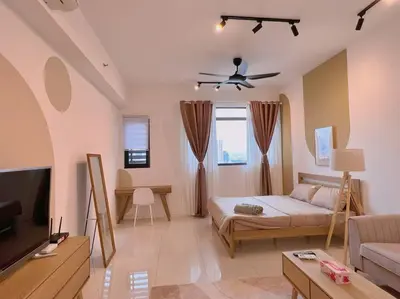 a living room with a bed and a flat screen tv at Cozy & Homely Chambers KL@3 Mins Walking Distance to LRT & Monorail in Kuala Lumpur