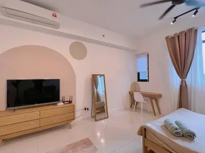 a living room with a flat screen tv on a wall at Cozy & Homely Chambers KL@3 Mins Walking Distance to LRT & Monorail in Kuala Lumpur