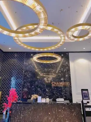 a room with a chandelier and a poster on the wall at Cozy & Homely Chambers KL@3 Mins Walking Distance to LRT & Monorail in Kuala Lumpur