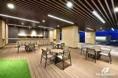 a restaurant with tables and chairs in a building at Infinity pool! High Speed WiFi! Rica Residence! in Kuala Lumpur