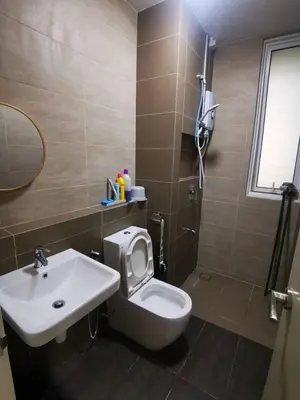 a bathroom with a white toilet and a sink at Infinity pool! High Speed WiFi! Rica Residence! in Kuala Lumpur