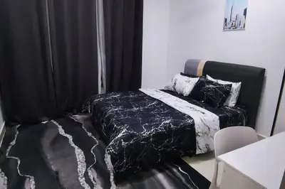 a black and white bedroom with a bed and a table at Infinity pool! High Speed WiFi! Rica Residence! in Kuala Lumpur