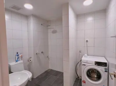a bathroom with a toilet and a washing machine at Comfy & Cozy Chambers KL, Near PWTC & Sunway Putra Mall in Kuala Lumpur