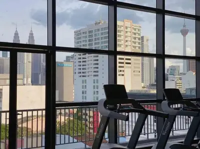 a gym with two chairs and a view of the city at Comfy & Cozy Chambers KL, Near PWTC & Sunway Putra Mall in Kuala Lumpur