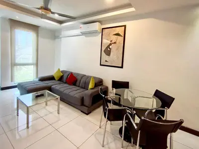 a living room with a couch and a glass table at BBHomes at Bukit Bintang Casa Residency KL in Kuala Lumpur
