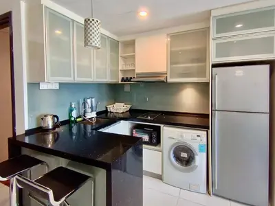 a kitchen with a white refrigerator and a dishwasher at BBHomes at Bukit Bintang Casa Residency KL in Kuala Lumpur