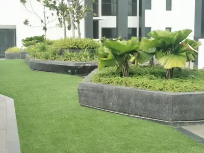 a garden with grass and palm trees in a building at BBHomes at Continew Residensi Pudu KL digitalife in Kuala Lumpur