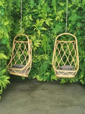 two bird cages hanging from a green wall at BBHomes at Continew Residensi Pudu KL digitalife in Kuala Lumpur