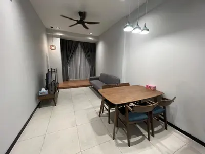 a dining room with a table and a couch at Opus Residences 1 Bedroom Apartment in Kuala Lumpur
