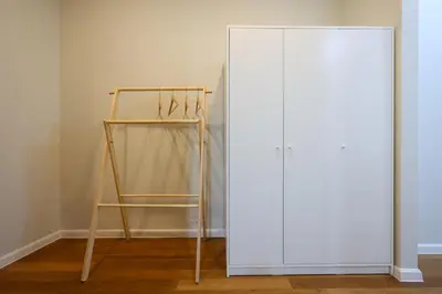 a white closet with a shelf and a white door at Sky Suites KLCC By Calm Sojourn in Kuala Lumpur