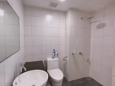 a white bathroom with a toilet and a shower at Spacious Connecting Room 4px, Chambers Residence KL, Walking Distance to LRT, MRT, Sunway Putra Mall & PWTC in Kuala Lumpur