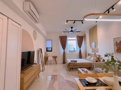 a large living room with a couch and a tv at Spacious Connecting Room 4px, Chambers Residence KL, Walking Distance to LRT, MRT, Sunway Putra Mall & PWTC in Kuala Lumpur