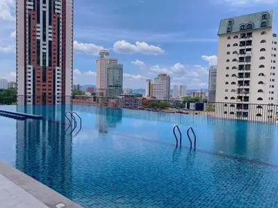 a swimming pool with two metal swans in the water at Spacious Connecting Room 4px, Chambers Residence KL, Walking Distance to LRT, MRT, Sunway Putra Mall & PWTC in Kuala Lumpur