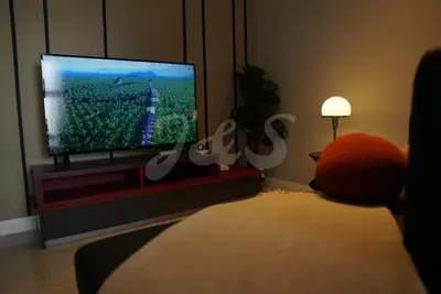 a living room with a flat screen tv on a stand at The Ress - The Axon Bukit Bintang Residence in Kuala Lumpur