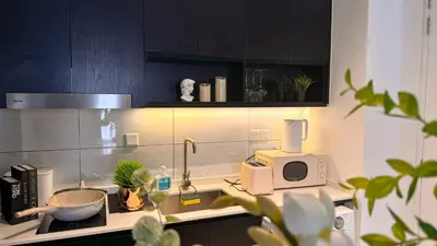 a kitchen with a counter with a sink and a microwave at The Ress - The Axon Bukit Bintang Residence in Kuala Lumpur