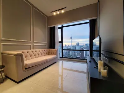 a living room with a couch and a large window at The Ress - The Axon Bukit Bintang Residence in Kuala Lumpur