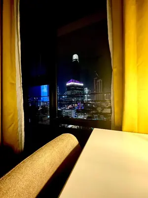 a room with a view of a city at night at Axon Suites Bukit Bintang by Prestige in Kuala Lumpur