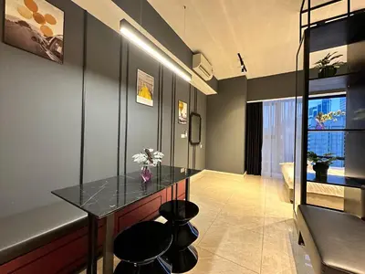 a dining room with a glass table and stools at Axon Suites Bukit Bintang by Prestige in Kuala Lumpur