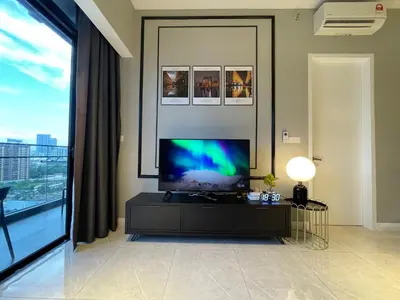 a living room with a flat screen tv on a wall at Axon Suites Bukit Bintang by Prestige in Kuala Lumpur