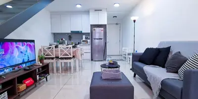 a living room with a couch and a kitchen at EkoCheras Loft 5 pax, #SoccerTable #AboveMall #Cozy #FreeCarPark in Kuala Lumpur