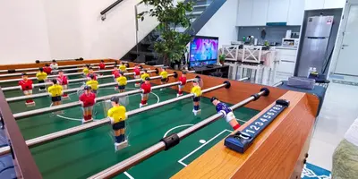 a group of toy people playing a game of table tennis at EkoCheras Loft 5 pax, #SoccerTable #AboveMall #Cozy #FreeCarPark in Kuala Lumpur