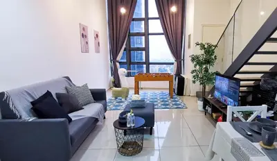 a living room with a couch and a tv at EkoCheras Loft 5 pax, #SoccerTable #AboveMall #Cozy #FreeCarPark in Kuala Lumpur