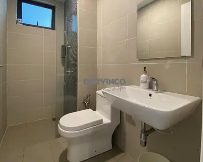 a bathroom with a sink and a toilet and a mirror at Continew at 35 floor - 5pax - KL - TRX - 2 Bedroom in Kuala Lumpur