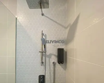 a shower in a bathroom with white hexagonal tiles at Continew at 35 floor - 5pax - KL - TRX - 2 Bedroom in Kuala Lumpur