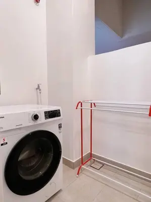 a washing machine sitting in a white room with at Ample 2BR 4px Seputeh @ Near MidValley & Garden Mall, Old Klang Road in Kuala Lumpur