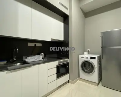 a kitchen with a washing machine and a washer at The Luxe - 3 pax - KLCC View - Balcony at 27 floor in Kuala Lumpur