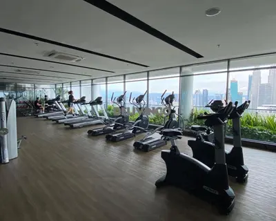 a gym with a row of treadmills and people exercising at The Luxe 2 pax Studio at KL - Microwave - Washer in Kuala Lumpur