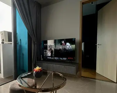 a living room with a tv and a glass table at The Luxe - Balcony at 42 floor - KLCC View - 3 pax in Kuala Lumpur