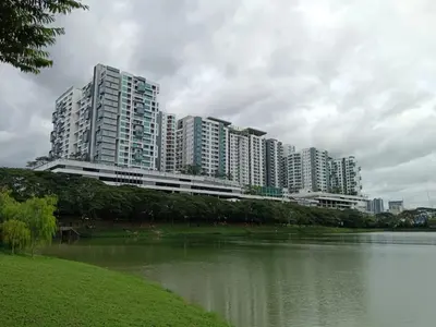 a group of tall buildings next to a body of water at Setapak Central Mall KL - Zetapark Garden Suites in Kuala Lumpur