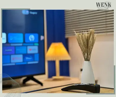a vase on a desk with a lamp and a computer at Neu Suites @ 3rdNvenue 003 in Kuala Lumpur