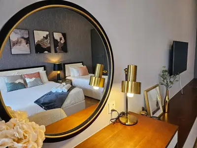 a bedroom with two beds and a large mirror at Luxurious Ceylonz Suite near Bukit Bintang 4pax in Kuala Lumpur