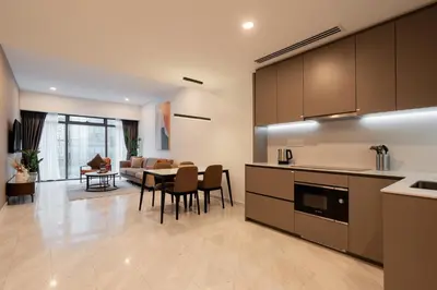 a kitchen and living room with a table and chairs at Eaton Residences by Sutera at KLCC in Kuala Lumpur