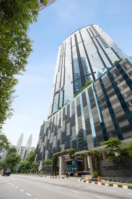 a tall building with a street in front of it at Eaton Residences by Sutera at KLCC in Kuala Lumpur