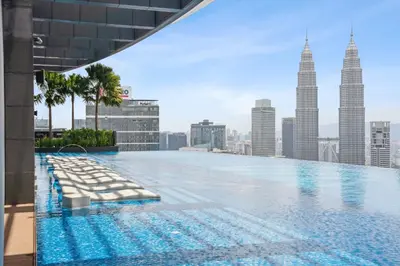 a swimming pool on the roof of a building with tall buildings at Eaton Residences by Sutera at KLCC in Kuala Lumpur