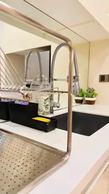 a kitchen counter with a sink and a mirror at Soho Suites KLCC By Grand KL in Kuala Lumpur
