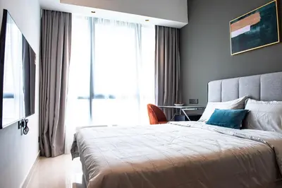 a bedroom with a large bed and a window at Stay @ NOVO Ampang in Kuala Lumpur