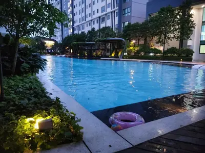 a large swimming pool in a city at night at M Centura Sentul 2 bedrooms with pool in Kuala Lumpur