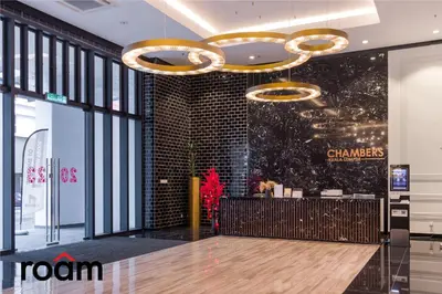 a lobby of a chanel store with a wooden floor at Chambers Residence, Sunway Putra Mall in Kuala Lumpur