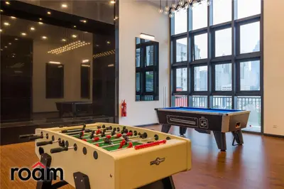a room with a foosball table and a pool table at Chambers Residence, Sunway Putra Mall in Kuala Lumpur