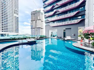 a large swimming pool in a city with tall buildings at Arte plus by sweet home 2BR in Kuala Lumpur