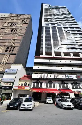 two tall buildings with cars parked in front of them at Red M101 by Oak Tree in Kuala Lumpur