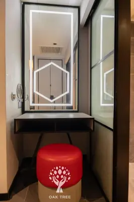 a red ottoman sitting under a desk with a window at Red M101 by Oak Tree in Kuala Lumpur