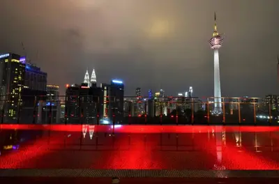 a view of a city skyline at night with the space needle at Red M101 by Oak Tree in Kuala Lumpur