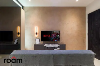 a room with a bed and a tv on a wall at Datum Jelatek Sky Residence Kuala Lumpur, Roam in Kuala Lumpur