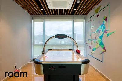 a room with a ping pong table in front of a window at Datum Jelatek Sky Residence Kuala Lumpur, Roam in Kuala Lumpur